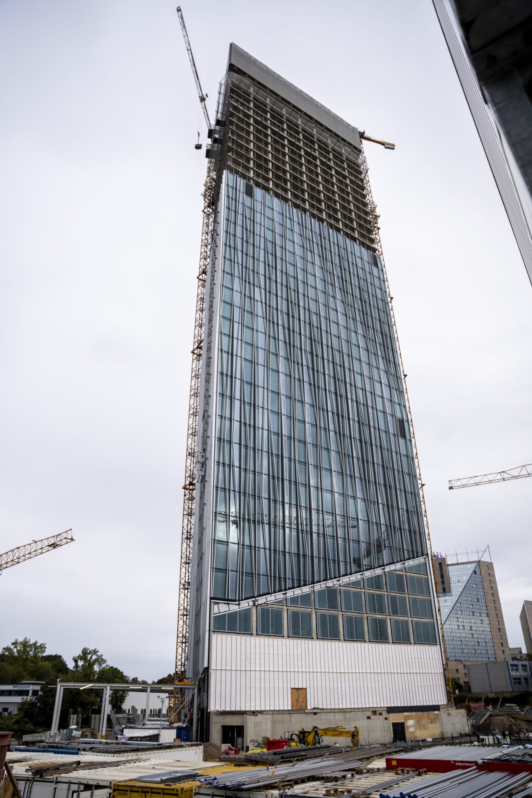 Im Juli 2021 begannen die Tiefbauarbeiten. Der Bau – eine Stahlbetonkonstruktion mit einschaliger Glasfassade – wird voraussichtlich Ende 2025 abgeschlossen sein. Vorgestellte Aluminium-Finnen wurden speziell an die Sonneneinstrahlungen vor Ort angepasst, um zusammen mit der Sonnenschutzverglasung und geschlossenen Fassadenteilen das Aufheizen der Räume im Sommer zu vermeiden.