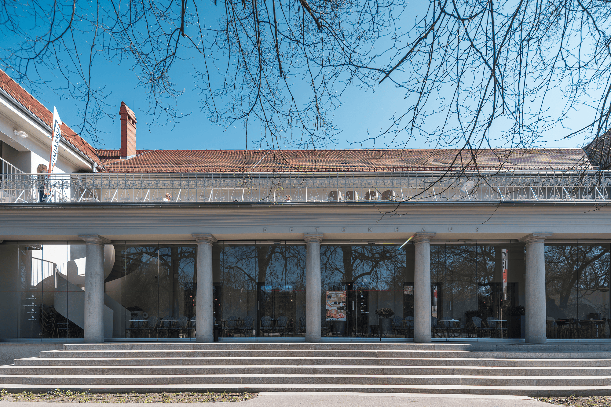 1911 wurde das "Betonhaus" als Ausstellungshalle für die große Gewerbeausstellung der Provinz Posen eröffnet. Über 100 Jahre später lassen umfassende Sanierungs- und Renovierungsmaßnahmen das Gebäude wieder in alter Schönheit erstrahlen. Für die moderne Optik mit großflächiger Fensterfassade zum Wilson Park kam das MSW-Glasschiebewandsystem von Geze zum Einsatz.
